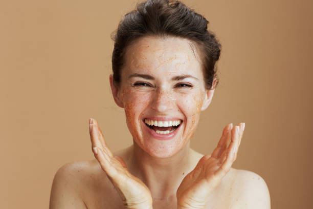 istock smiling modern woman with face scrub against beige background 1481439292