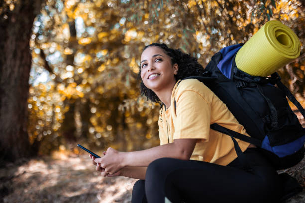 istock Young woman hiking in nature using phone 1481443051