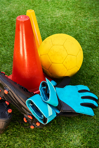 Football boots and training equipment on grass