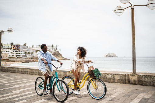 Young couple during a bike ride on the coastline