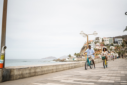 Young couple during a bike ride on the coastline