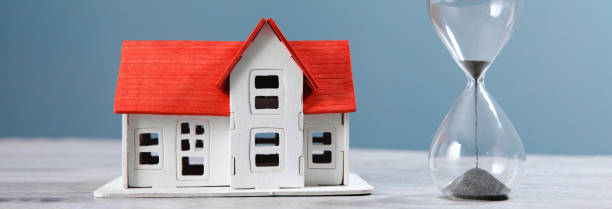 istock house model and hourglass on table 1481444338