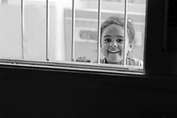 istock Young Black Girl Looking Out The Window 1481445331