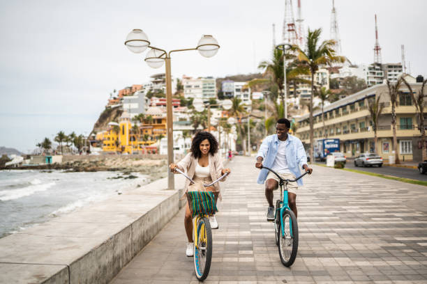 Young couple during a bike ride on the seacoast