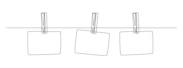 Photo frames hanging on the rope with clothespins in one continuous line drawing. Clothesline with pin and peg for photo album design concept in simple linear style. Editable stroke. Vector Photo frames hanging on the rope with clothespins in one continuous line drawing. Clothesline with pin and peg for photo album design concept in simple linear style. Editable stroke. Vector. photos hanging string stock illustrations