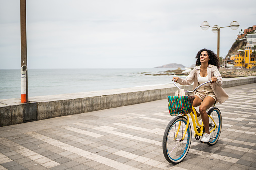 Young woman using a bike on the seacoast