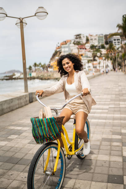 istock Young woman using a bike on the seacoast 1481445915