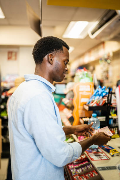 istock Young man paying at a retail store 1481446765