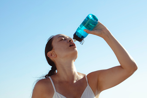 A woman cools down with cold water during the summer heat.