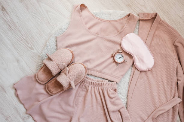 Flat lay composition with house slippers, sleeping mask and pajamas on light background