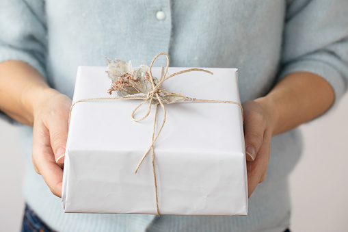 Woman showing gift box.