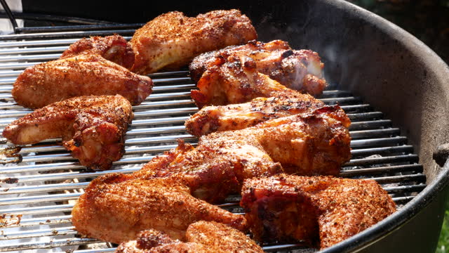 Cooking flavored chicken wings on the barbecue