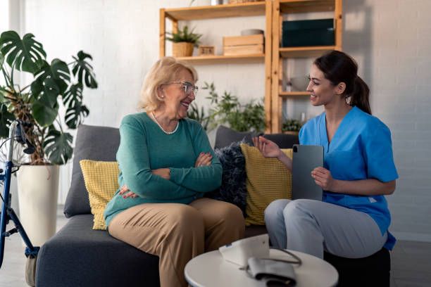 istock Nurse talking to senior woman during home visit 1481454633