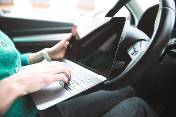 istock A woman uses a laptop in a car 1481458051