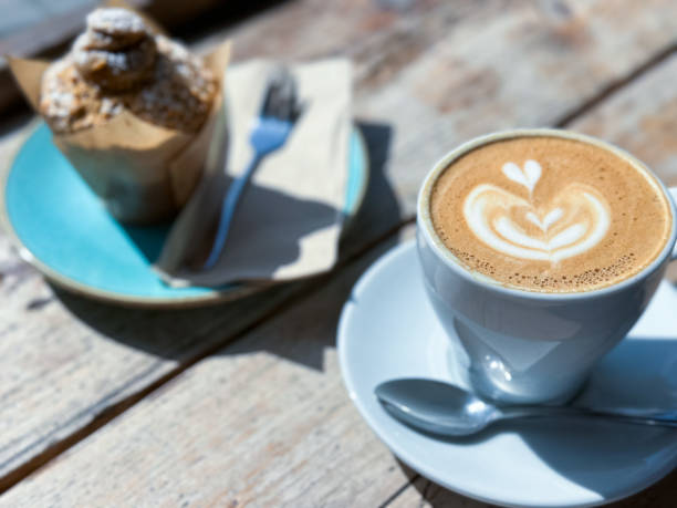 istock Cup of fresh flat white or latte coffee with muffin 1481458850