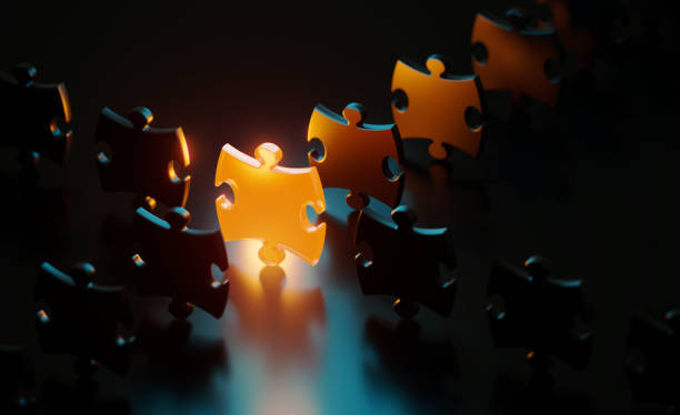 istock Orange Jigsaw Puzzle Piece Glowing Amid Black Jigsaw Pieces On Black Background 1481463656