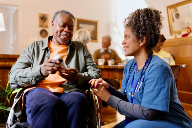 istock Caring nurse talking with a man in a wheelchair 1481467948