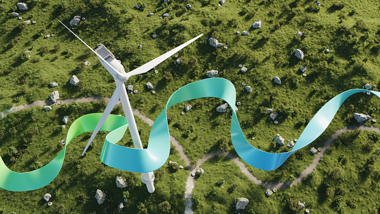 Aerial view of a wind turbine and colorful ribbon flowing past