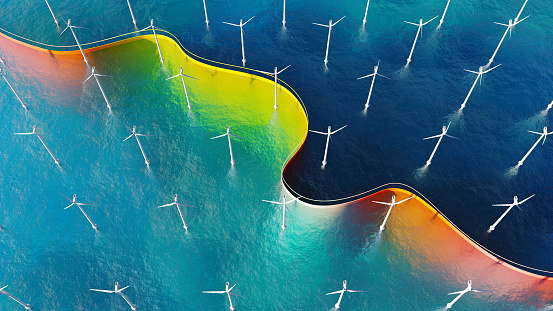 Aerial view of a seascape with wind turbines and a ribbon flowing through