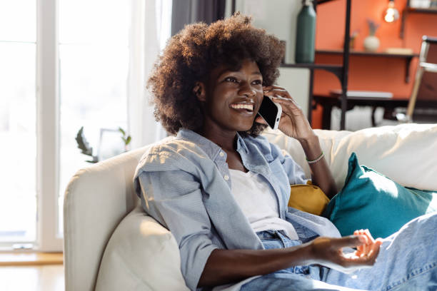 istock A lovely Black woman is smiling while using smart phone 1481468675