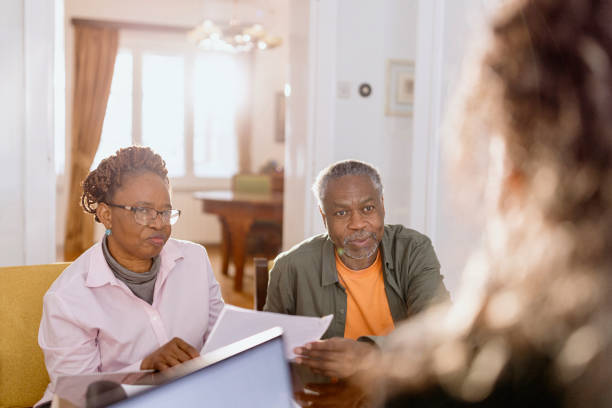 istock Smiling couple talking with a tourist agent 1481468811