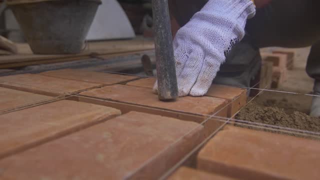 Construction worker placing brick