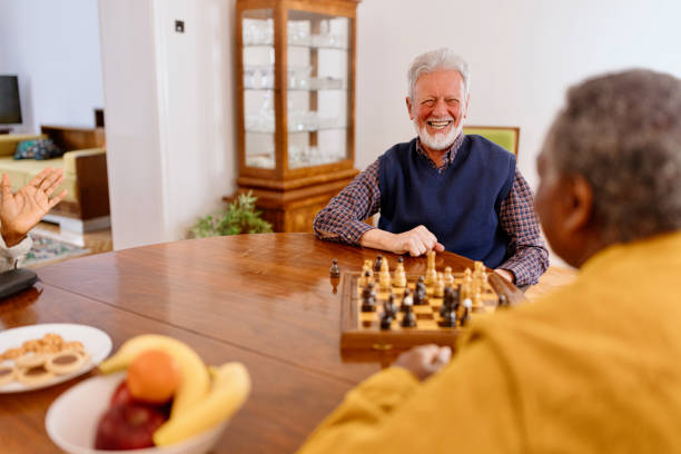 istock Smiling senior man playing chess with his friend 1481472832
