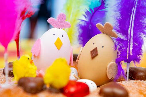 Easter cake detail full with color, chocolate hearts and feathers.