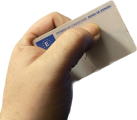 Hand with European driving license. Permission to drive cars and motor vehicles of the European community and the Spanish nation. Guide card.