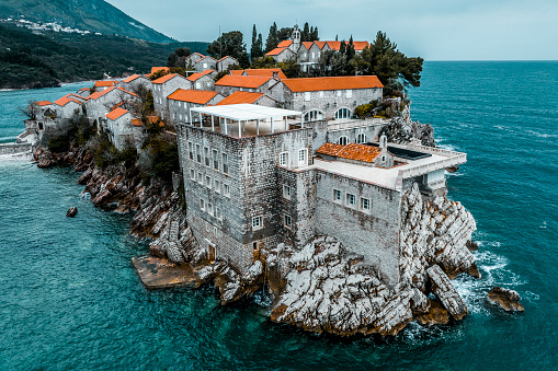 Beautiful and unique Sveti Stefan island in Montenegro captured with a drone during one cloudy spring day.
