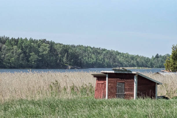 istock red shed on field in front of lake 1481480688