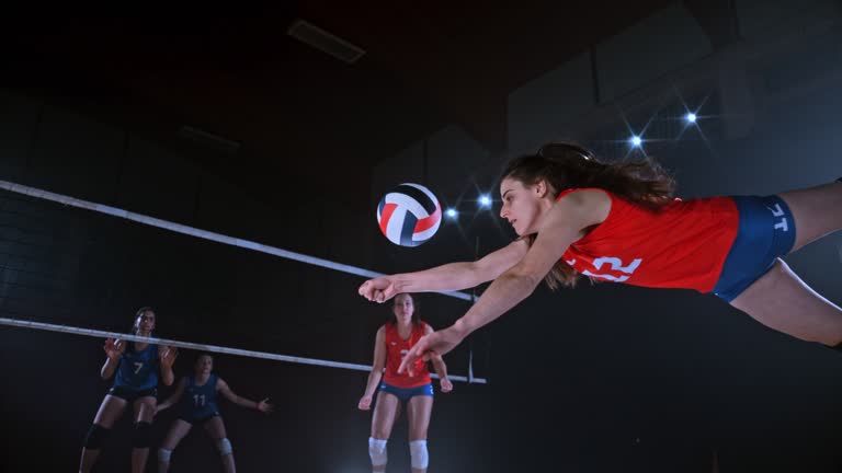 SLO MO LD Female player diving and saving the volleyball