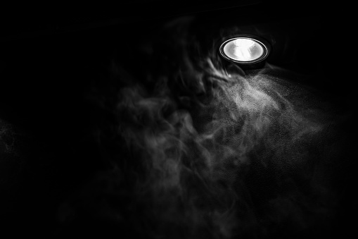 an abstract background with illuminated smoke. a decor of smoke and lamp. smoke vapor in the dark