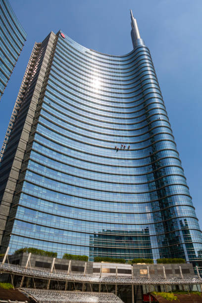 istock A glass building with window washers descending the facade on ropes 1481486374