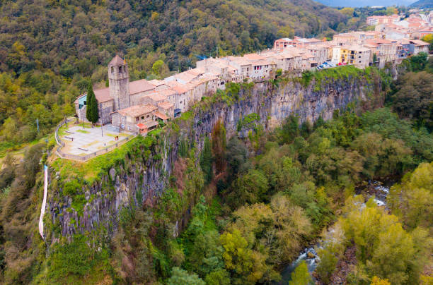 Aerial view of Castellfollit de la Roca, medieval Catalan hamlet on cliff on autumn day
