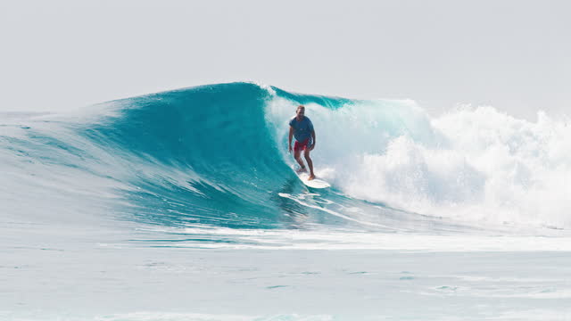 Surfer rides the big wave in the Maldives, Sultans surf spot during big swell day