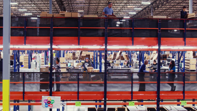 Drone Moving Right Capturing Diverse Group Of Employees Working In a Fulfillment Center