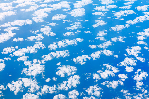 High cirrocumulus clouds over blue sea