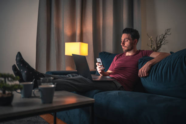 istock Mid Adult Caucasian Single Man Sitting On The Couch Using Technology 1481515058