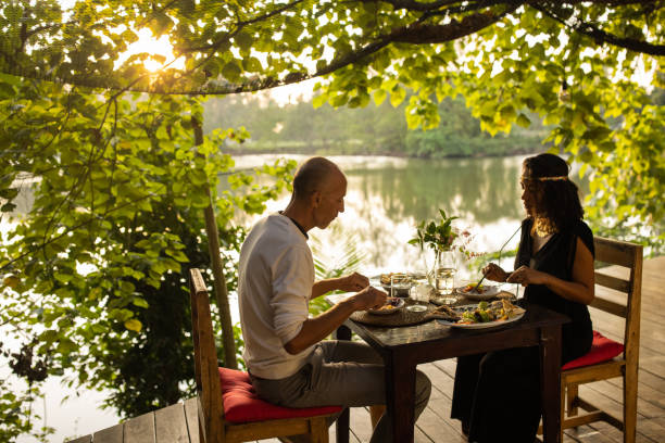 istock Couple dining in restaurant by the river 1481520299