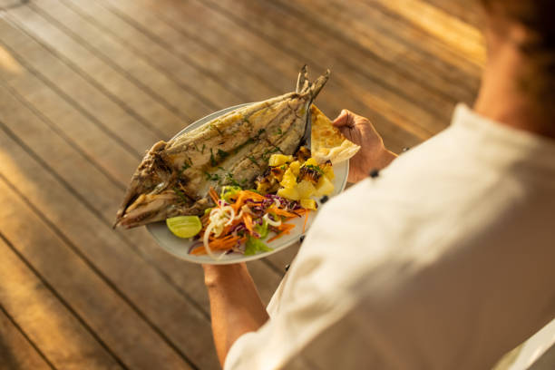istock Waiter carrying fish meal 1481522513