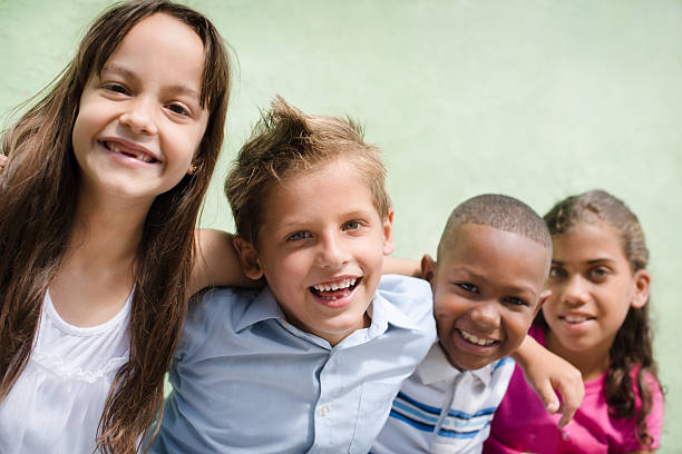 istock happy children hugging, smiling and having fun 148152958