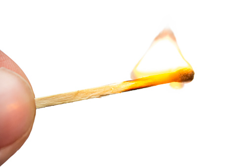 Burning match on a white background. The concept of a fire extinguishing system, security.