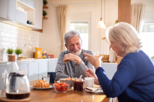 istock Senior couple having breakfast together at home 1481545753