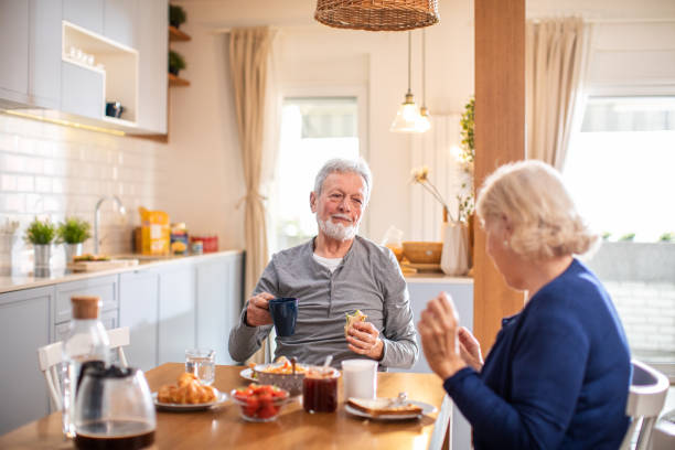 istock Senior couple having breakfast together at home 1481546060