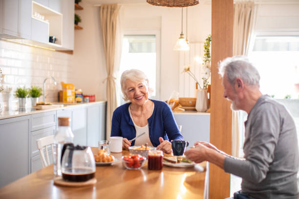 istock Senior couple having breakfast together at home 1481546320