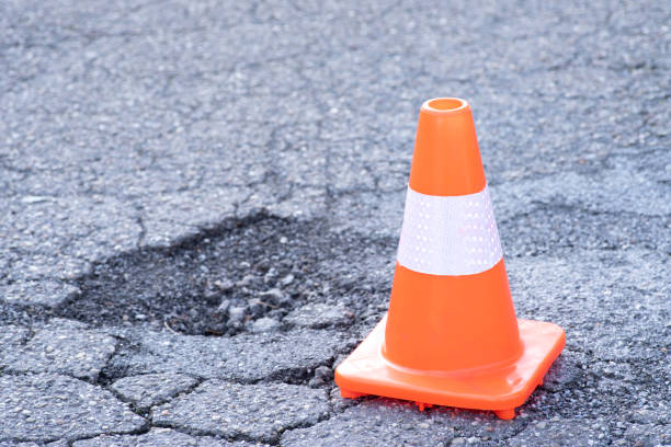 istock A traffic cone and pothole in a street 1481552181