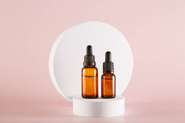 istock Two dropper bottles mockup stands in front of white circle. 1481553816