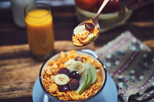 Cornflakes with Banana, Apples and Grapes for Breakfast
