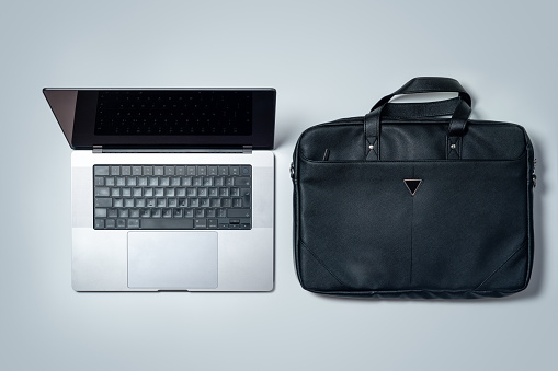 Modern laptop with a luxury business bag / laptop bag, directly above view